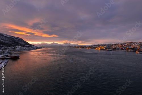 Sunset in the Fjords in Norway with snowy mountains