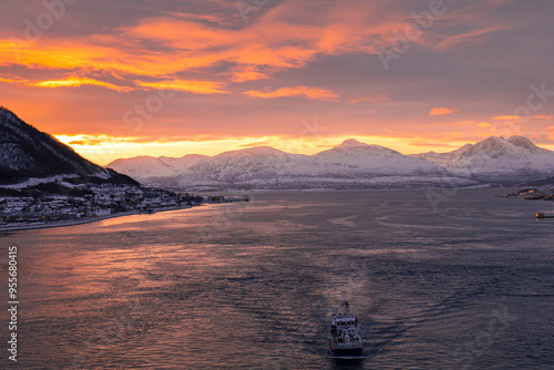 Sunset in the Fjords in Norway with snowy mountains