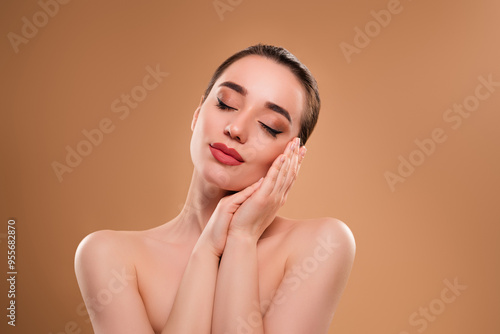 Photo of gorgeous dreamy peaceful lady closed eyes two enjoying pure and healthy skin isolated on beige background