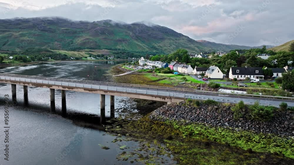 Aerial view of a rainbow over Eilean Donan Castle with long arched bridge and lochside setting. Scottish icon and a popular tourist attraction in the Highlands overlooking the Isle of Skye. Aerial view of a rainbow over Eilean Donan Castle with long arched bridge and lochside setting. Scottish icon and a popular tourist attraction in the Highlands overlooking the Isle of Skye.