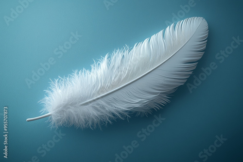 A single white feather gently resting on a clean, smooth surface, highlighting the beauty of minimalism. Concept of purity and simplicity.