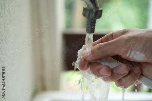 close up of a person washing a paint brush