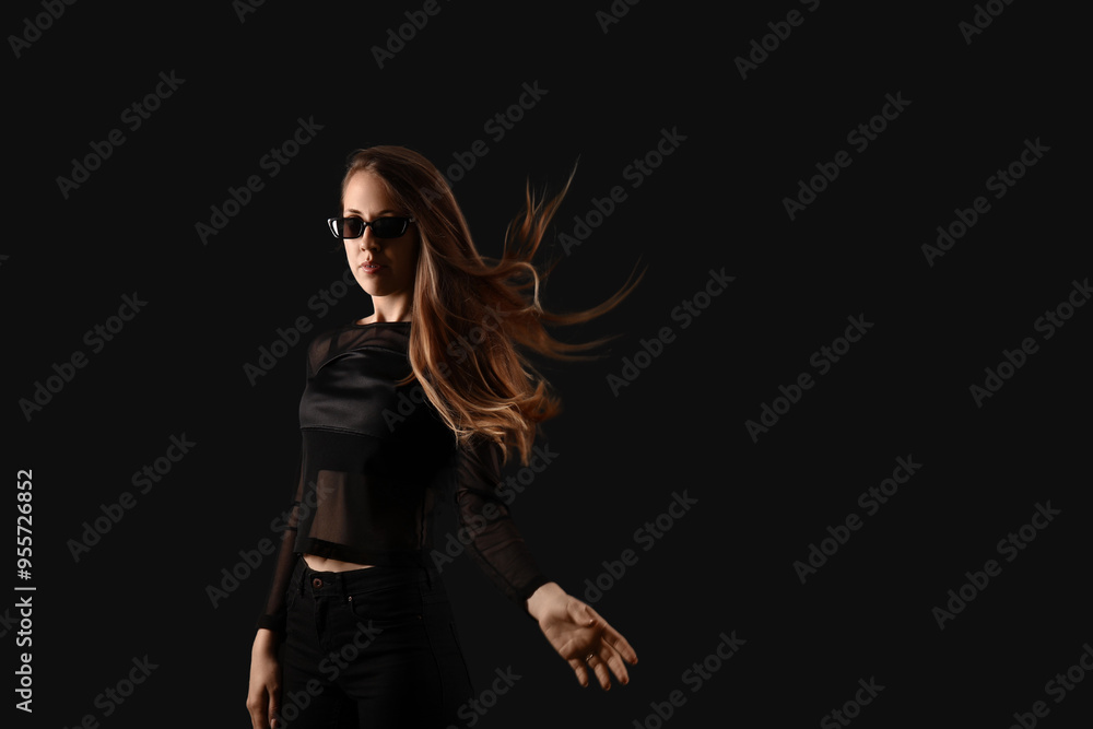 Young woman in sunglasses on dark background Young woman in sunglasses on dark background