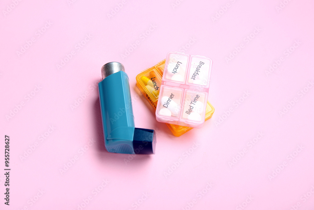 Asthma inhaler and boxes with pills on pink background Asthma inhaler and boxes with pills on pink background