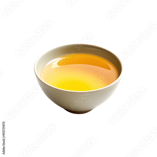 A close-up of a white teacup filled with golden yellow tea. The liquid is still and reflects the light.