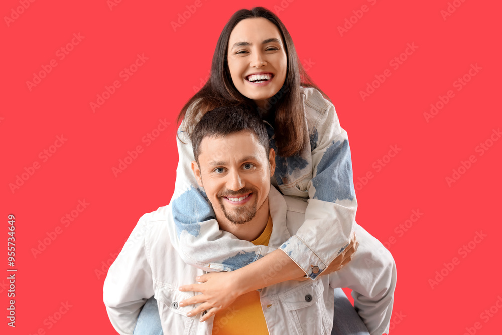 Obraz premium Happy young couple on red background