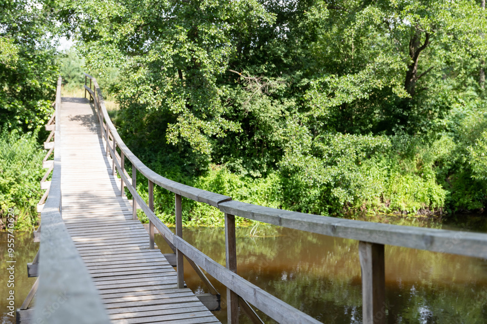 View of long wooden suspension bridge outdoors View of long wooden suspension bridge outdoors