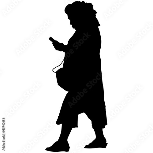 A woman walking while staring at a cell phone