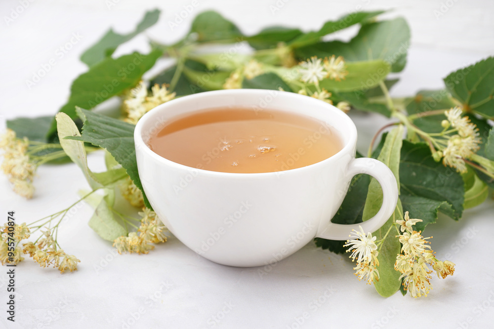 Cup of linden tea and leaves on white background Cup of linden tea and leaves on white background