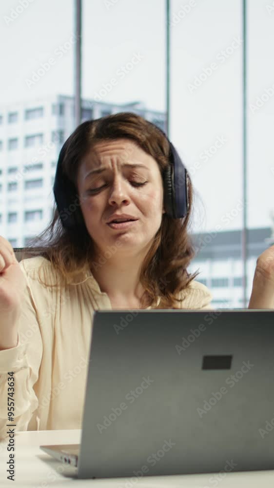Vertical Video Female entrepreneur enjoys multitasking with her favorite music on headset, singing and dancing at her CEO desk. Woman with leadership skills working on her business with songs. Camera Vertical Video Female entrepreneur enjoys multitasking with her favorite music on headset, singing and dancing at her CEO desk. Woman with leadership skills working on her business with songs. Camera