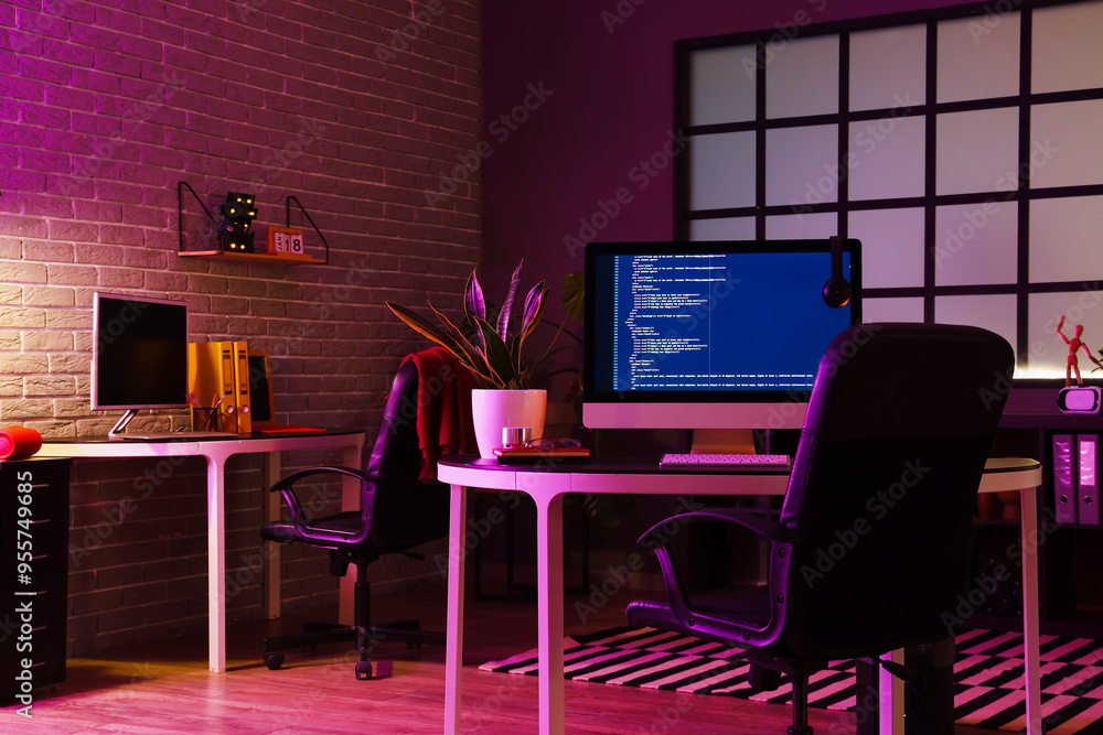 Interior of dark office with programmer's workplaces Interior of dark office with programmer's workplaces