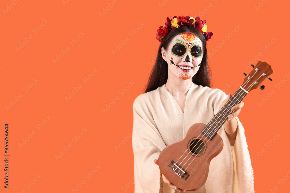 Beautiful woman dressed for Halloween with guitar on orange background Beautiful woman dressed for Halloween with guitar on orange background