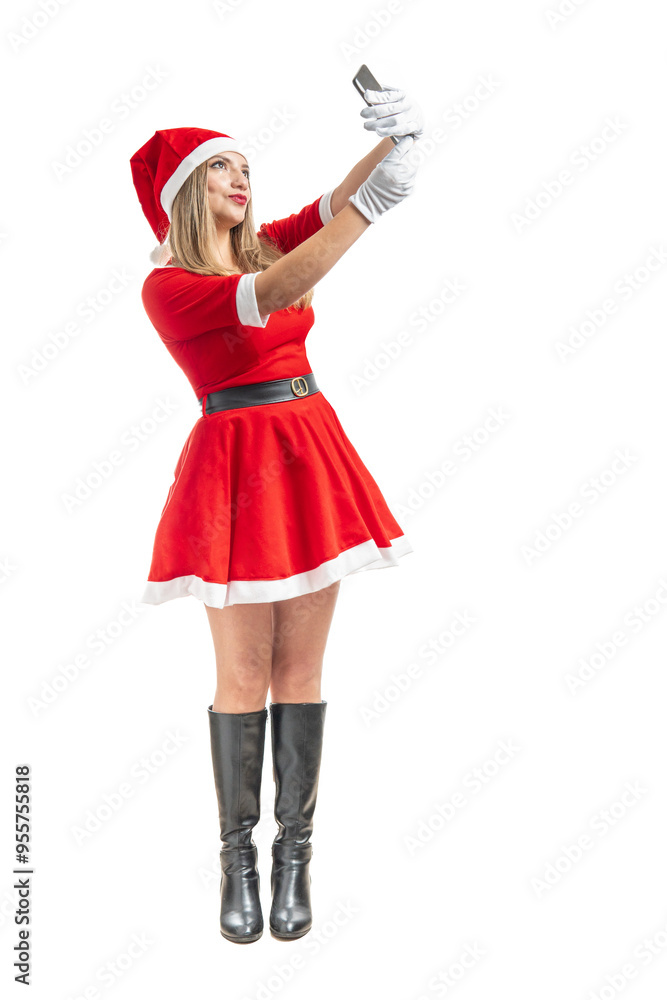 Full length blonde latina santa claus taking a selfie Full length blonde latina santa claus taking a selfie