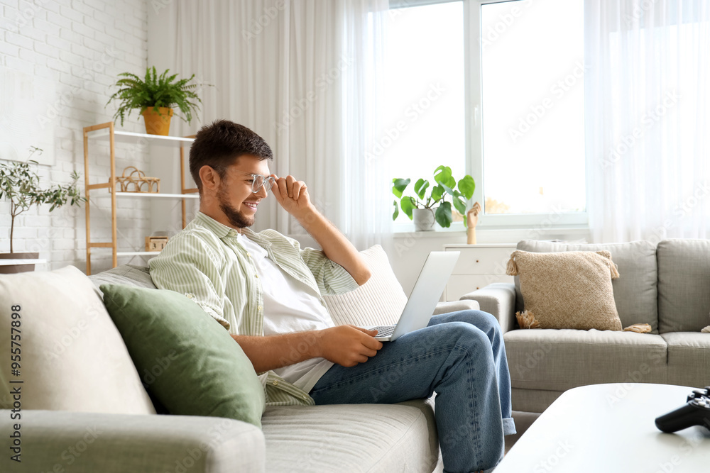 Young bearded man using laptop at home Young bearded man using laptop at home