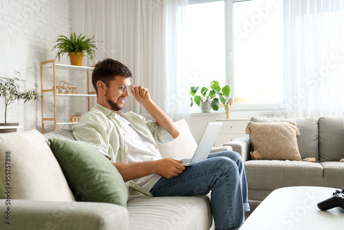 Young bearded man using lap...