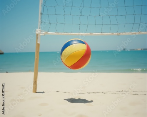 beach volleyball on the sand with a net in the middle, surrounded by water and a clear blue sky