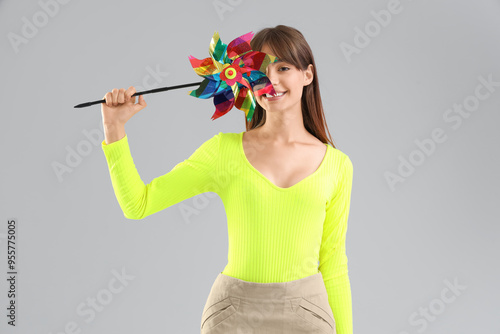 Young woman with toy windmi...