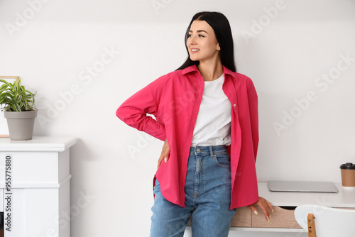 Young woman near desk at home