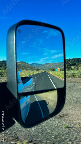 Mountain Road Reflection in Rearview Mirror