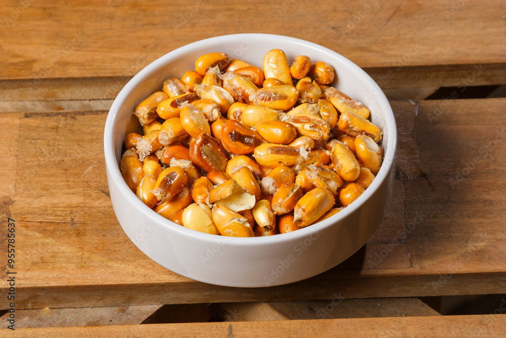 Crisp and golden roasted corn kernels served in a bowl. Crisp and golden roasted corn kernels served in a bowl.