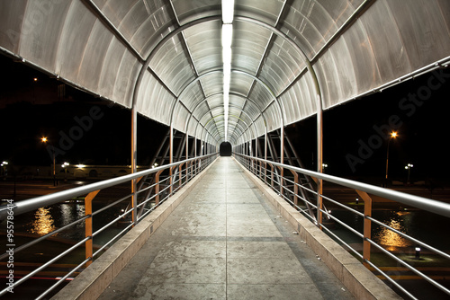 Symmetrical pedestrian overpass corridor with overhead lighting