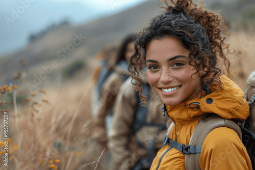 Young Woman Smiling While Hiking in Natural Landscape Wearing Yellow Jacket and Backpack