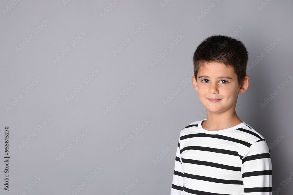 Portrait of cute little boy on grey background, space for text Portrait of cute little boy on grey background, space for text