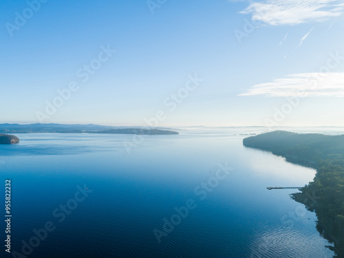 peaceful blue aerial view of coastal lake with calm waters photo