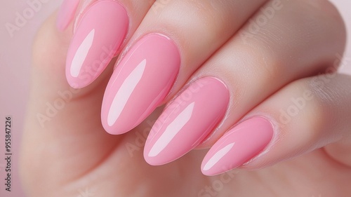 A hand with long pink nails