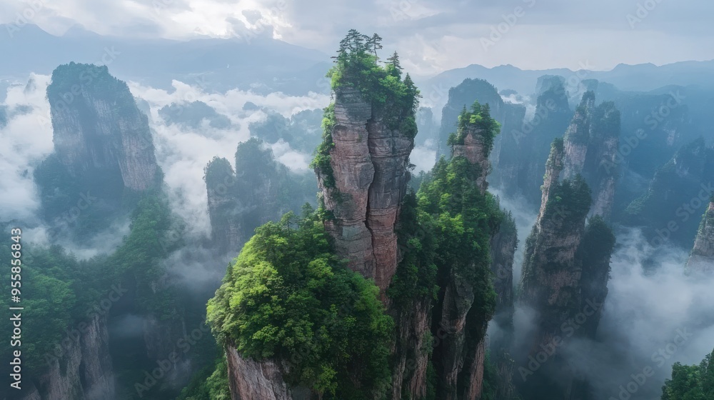 Majestic Tall Mountain Peaks Emerging from the Clouds in a Foggy Landscape Majestic Tall Mountain Peaks Emerging from the Clouds in a Foggy Landscape