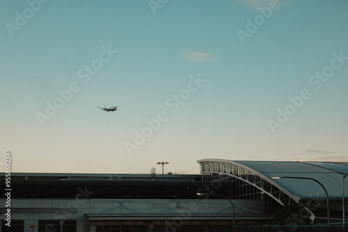 Airplane coming into land over Sydney Airport Domestic Terminal with copy space photo