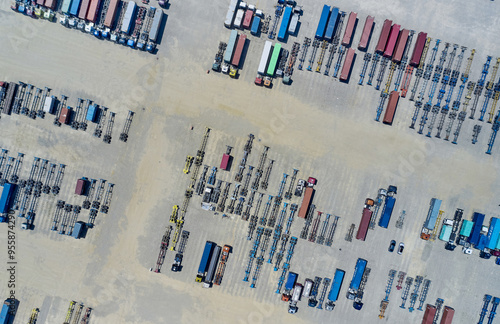 Songdo, Yeonsu-gu, Incheon, South Korea - July 25, 2021: Aerial and top angle view of trucks and containers on a parking lot of Incheon New Port in summer photo