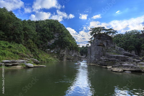 Cheorwon-gun, Gangwon-do, South Korea - September 5, 2021: Summer view of a pleasure boat on Hantan River besides cliff and Goseokjeong Pavilion