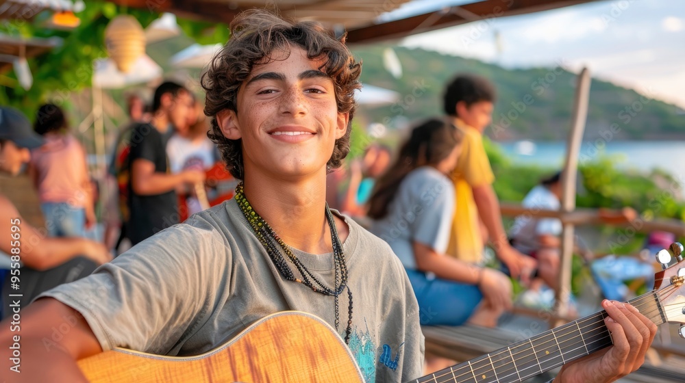 Young Man Playing Guitar on Beach at Sunset Young Man Playing Guitar on Beach at Sunset