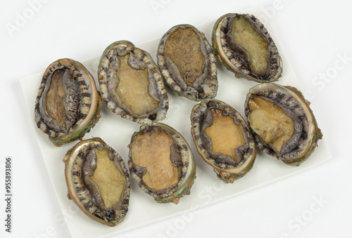 Close-up of raw abalones on white dish with background, South Korea