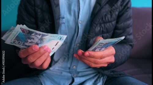 Man counts Peruvian 100 soles bills. photo