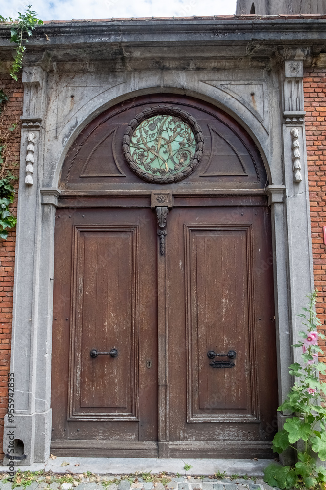 A rustic wooden door, richly adorned with intricate details, features a stunning and beautiful circular window A rustic wooden door, richly adorned with intricate details, features a stunning and beautiful circular window