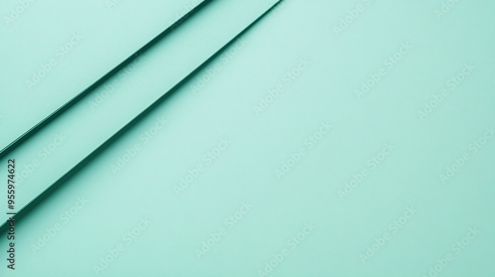 Close-up of smooth mint-colored paper sheets creating a calming and minimalistic background. Close-up of smooth mint-colored paper sheets creating a calming and minimalistic background.