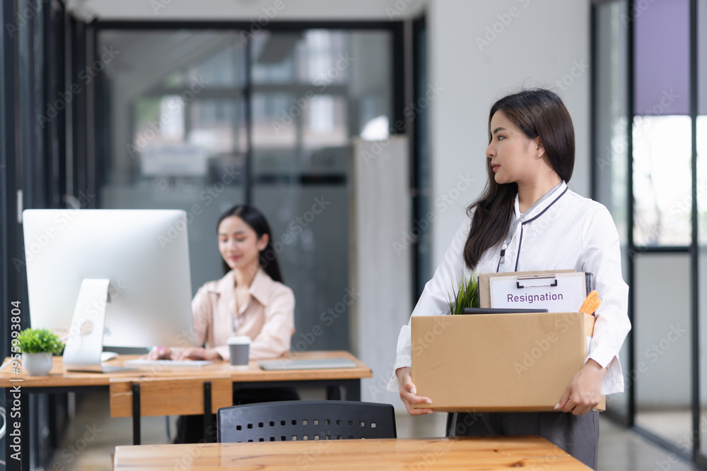 Young asian woman employee with a storage box for the equipment after resigning and stressed from work. Young asian woman employee with a storage box for the equipment after resigning and stressed from work.