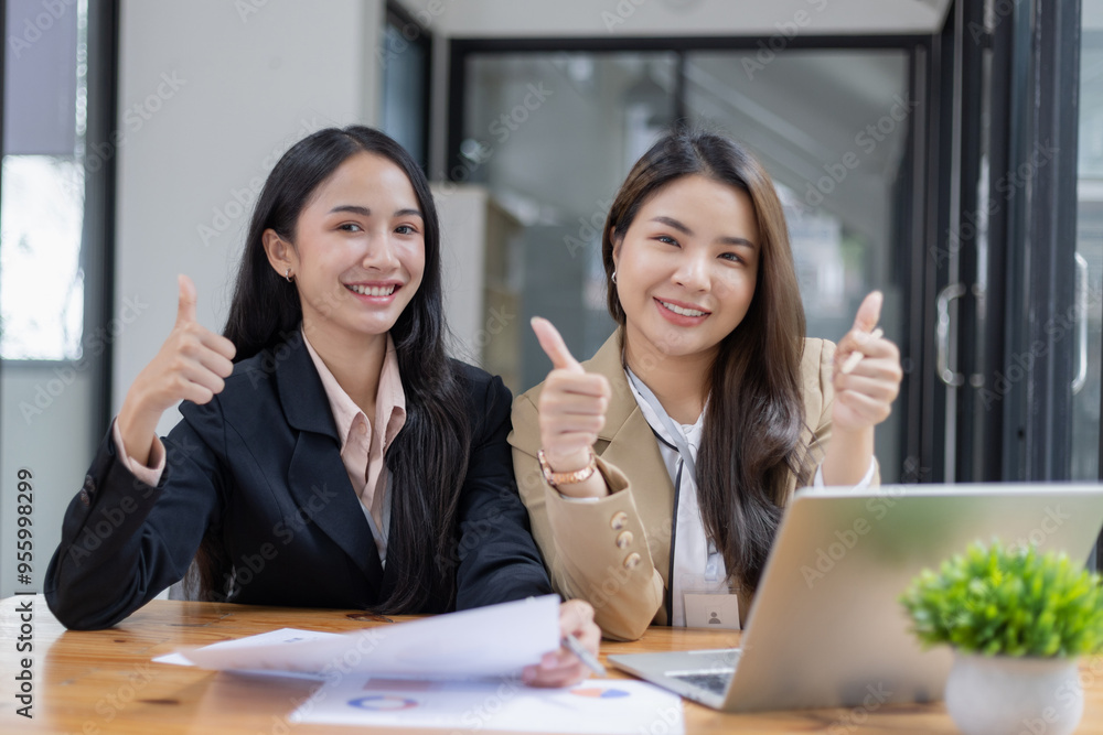 Two Asian businesswomen working on laptop computer with analyzing financial charts in the modern office, Business financial documents and planning idea project concept. Two Asian businesswomen working on laptop computer with analyzing financial charts in the modern office, Business financial documents and planning idea project concept.