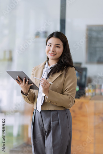 Young asian businesswoman using tablet to startup projects and business presentation plan.