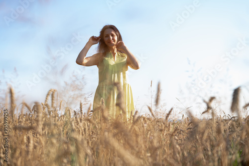 Wallpaper Mural portrait of a pretty young girl in a wheat field, smiling, in a yellow dress, place for writing, fields and nature of Ukraine Torontodigital.ca