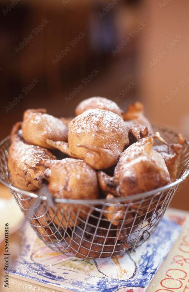 Freshly fried oliebollen a form of fried dough with a dusting of icing sugar Freshly fried oliebollen a form of fried dough with a dusting of icing sugar