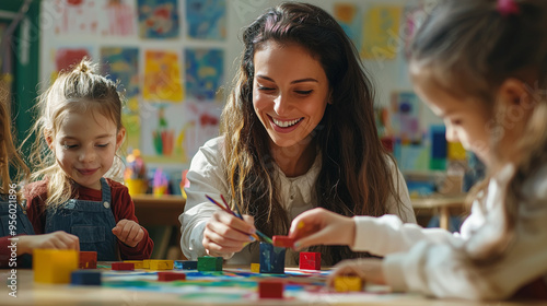 A kindergarten classroom decorated with colorful posters and drawings, young children painting and building with blocks, a teacher assisting them with a smile photo