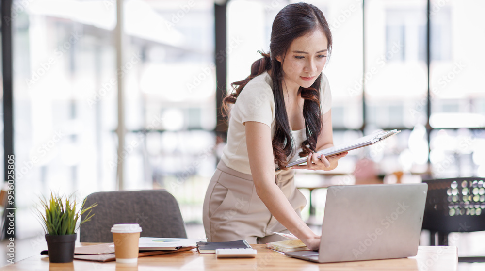 Busy asian business woman entrepreneur working in office checking legal document account invoice in office. Businesswoman of young manager executive or lawyer using laptop computer at work. Busy asian business woman entrepreneur working in office checking legal document account invoice in office. Businesswoman of young manager executive or lawyer using laptop computer at work.