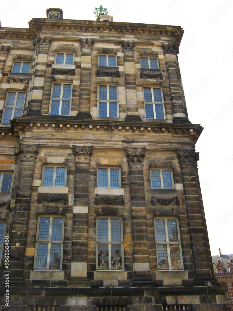 Royal Palace on Dam Square reveals its stately, symmetrical design with rows of tall arched windows. Royal Palace on Dam Square reveals its stately, symmetrical design with rows of tall arched windows.