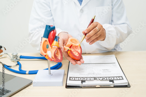 A female doctor works at a desk in the hospital,discussing heart diseases such as coronary artery disease,arrhythmia,heart valve stenosis,heart failure congenital heart disease, emphasizing symptoms