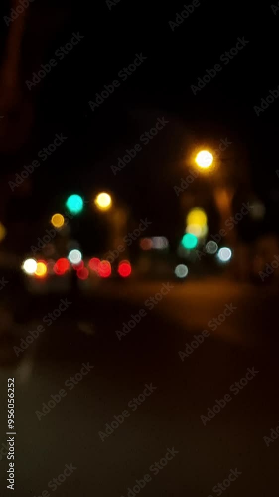 Blurred lights of cars at a road intersection of a large night city. City road background at night. Night background Blurred lights of cars at a road intersection of a large night city. City road background at night. Night background