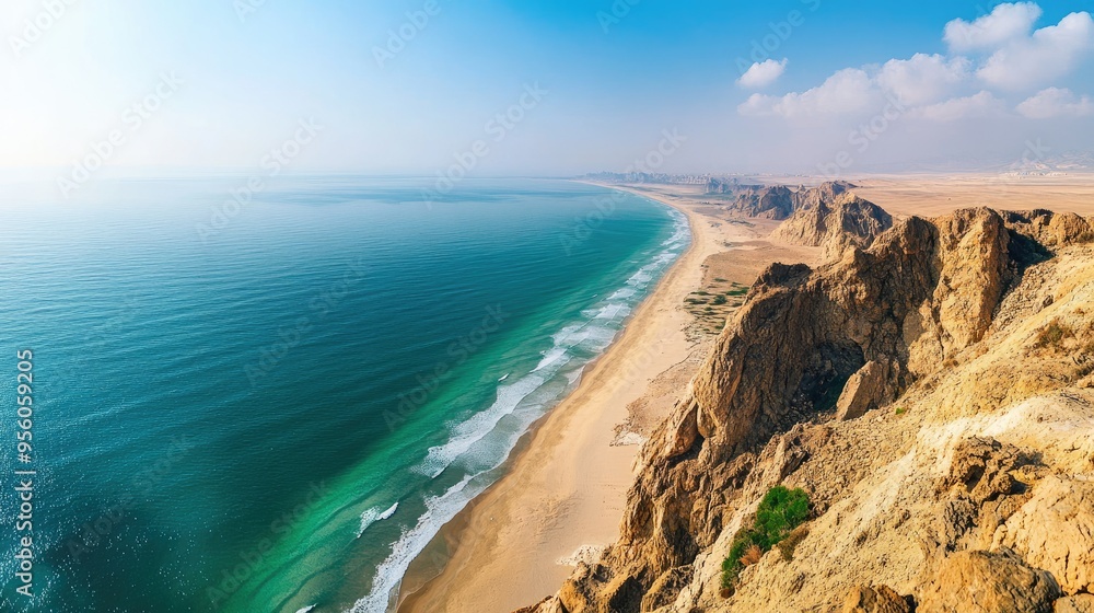 A panoramic view of the Ras Al Khaimah coastline, with sandy beaches, rocky cliffs, and the Arabian Gulf. A panoramic view of the Ras Al Khaimah coastline, with sandy beaches, rocky cliffs, and the Arabian Gulf.
