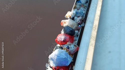 Piles of rubbish on the pillars of the Bengawan River bridge. Bojonegoro, Indonesia. photo